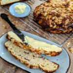 Ein knuspriges Osterbrot mit Quark und getrockneten Erdbeeren, liebevoll dekoriert mit einem Hauch von Mandelblättchen